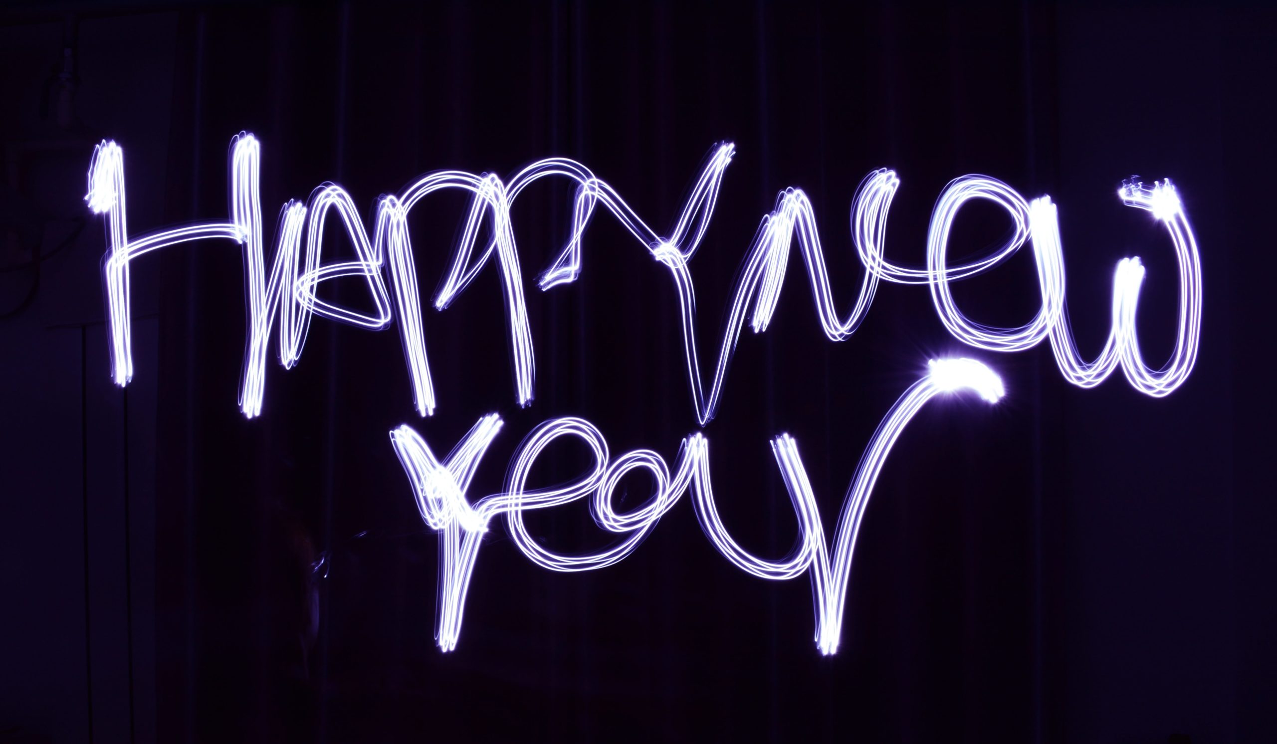 Happy New Year Text written in neon pinkish white